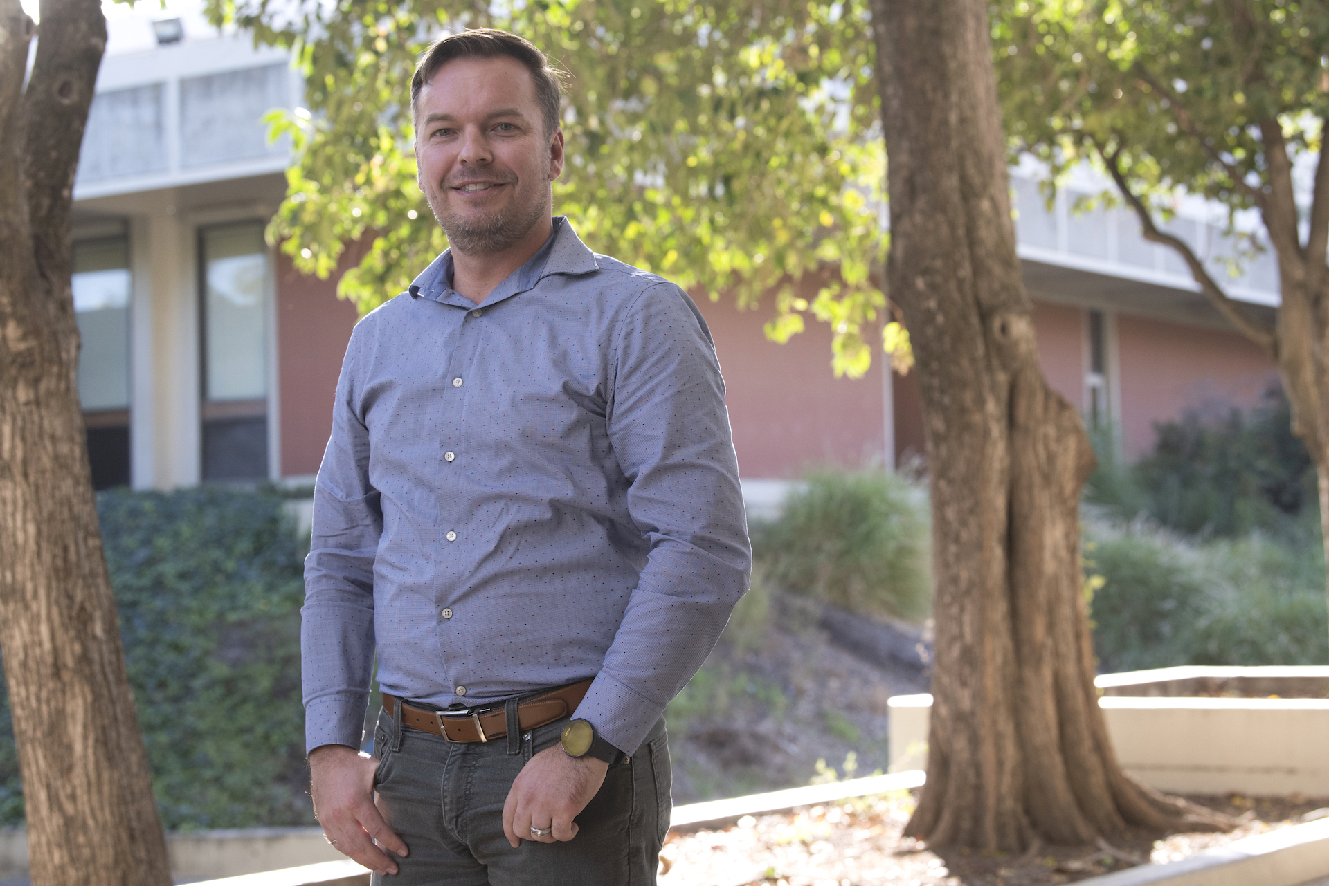 Jonathan Schofield stands with hands in pockets on UC Davis campus.