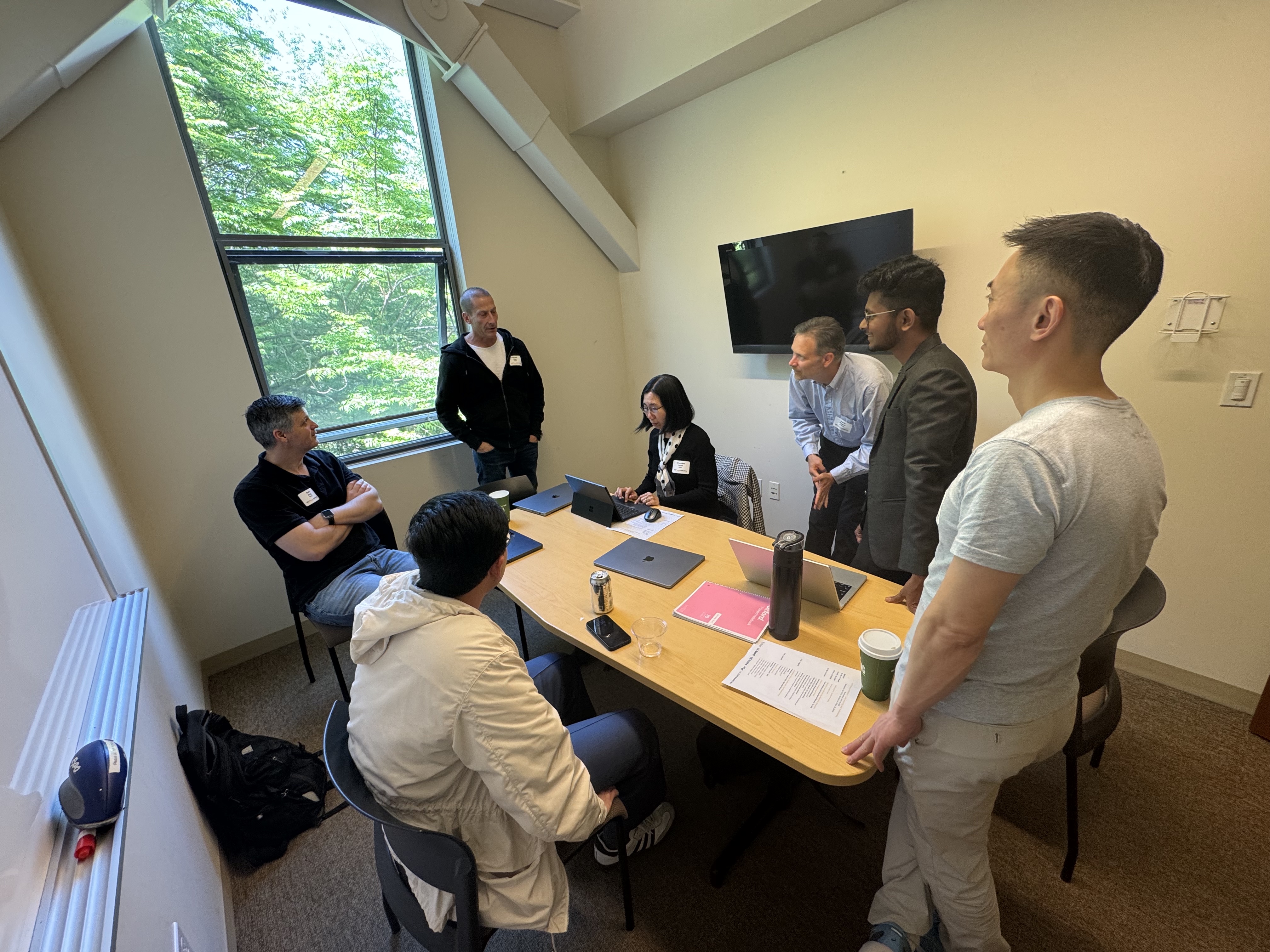seven researchers gather in a small breakout room to discuss cybersecurity grand challenges